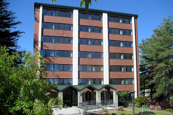 rick exterior and main entrance of Doughton Residence Hall surrounded by trees at App State
