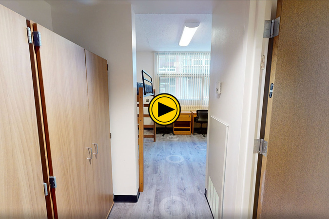 Virtual tour preview of Summit Hall showing storage, desk, bed, and window.