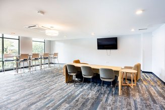 New River Hall lobby with study tables, lounge chairs, television and large windows