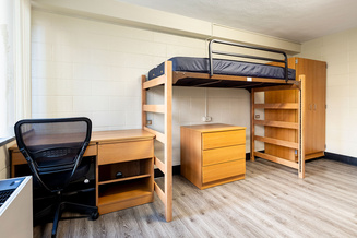 Furnished Doughton Hall bedroom with lofted bed, desks, chair, drawers and shelving