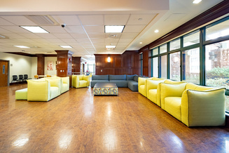 Spacious Elkstone Hall lobby with colorful sofas, armchairs, tables and large windows