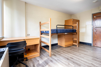 Elkstone Hall bedroom with lofted bed, desks, chair, storage drawers and shelving