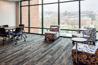 Thunder Hill Hall study lounge with group tables, individual seating and panoramic campus views.
