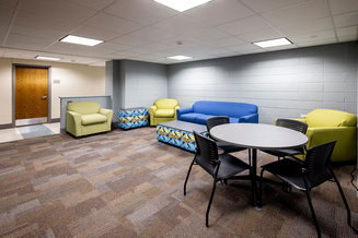 White Hall lounge with sofas, armchairs, tables and seating for studying or gathering.